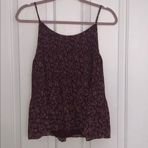Red/maroon tank top with white floral design